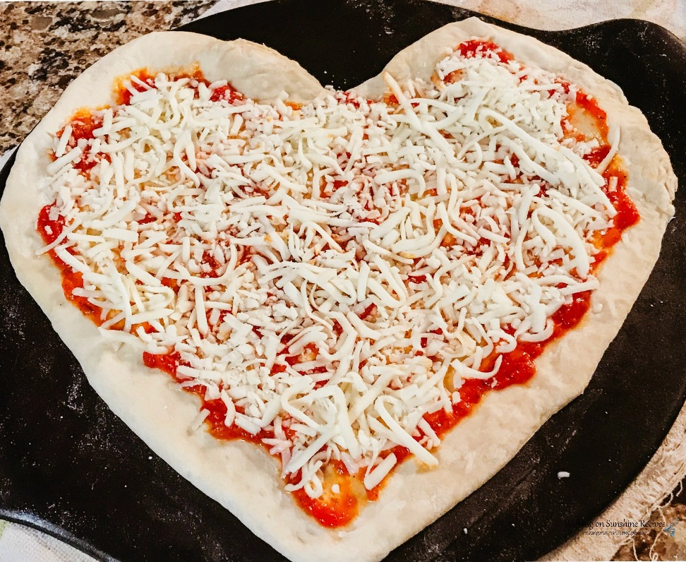 DIY pizza on Baking Stone with mozzarella cheese. 