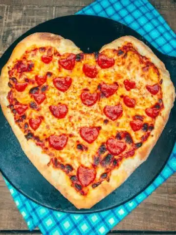 Heart shaped pizza with heart shaped pepperoni baked