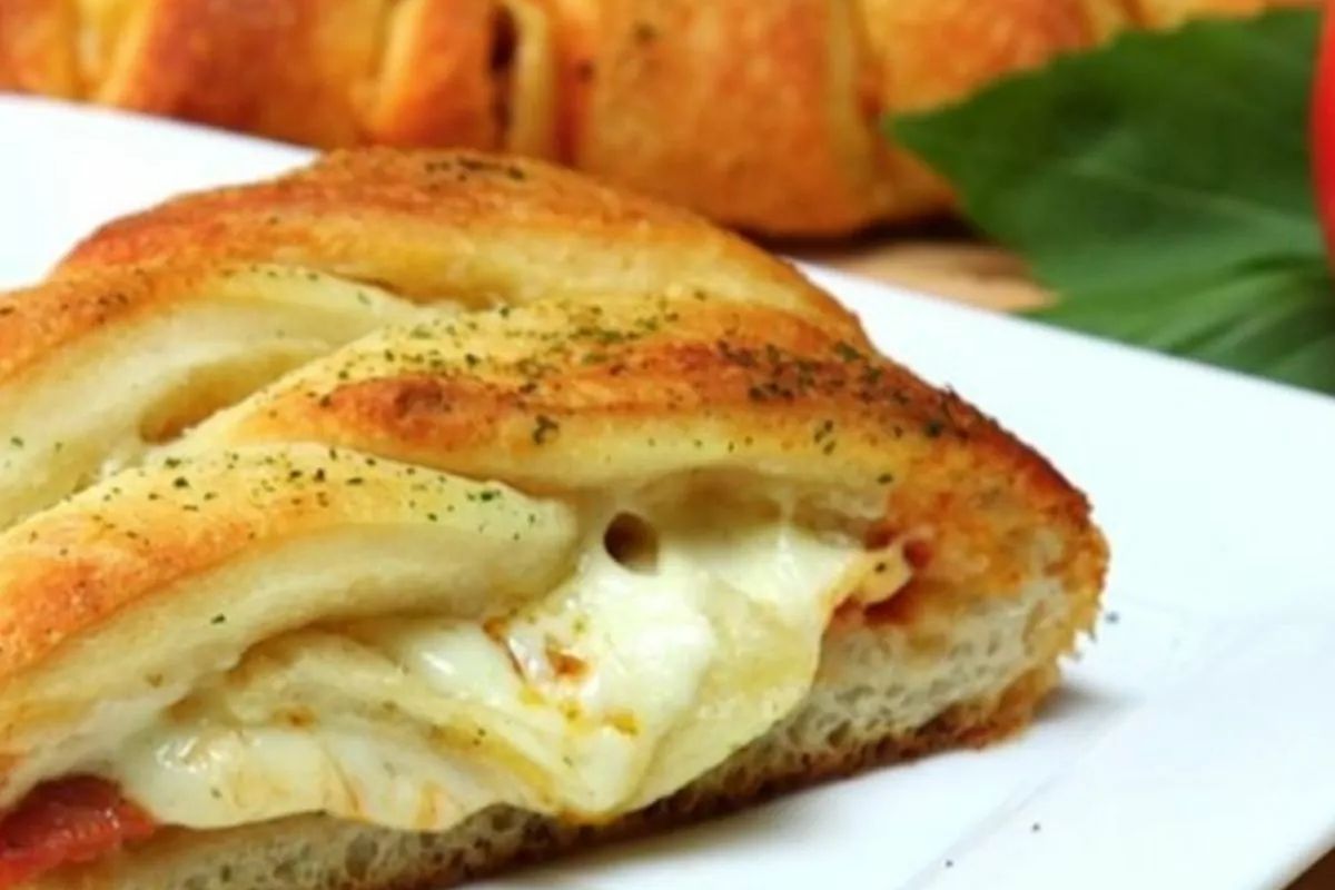 Slice of pizza braid on a white plate.