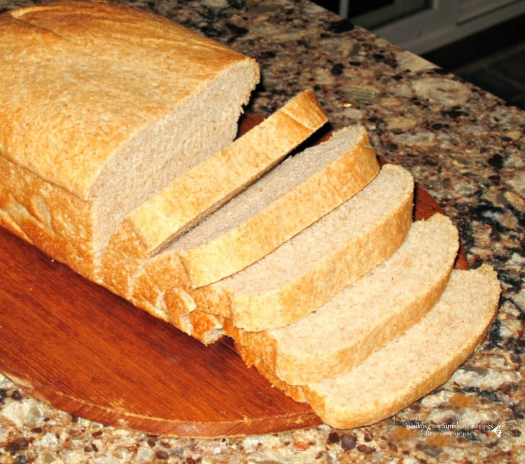Homemade bread sliced on cutting board. 