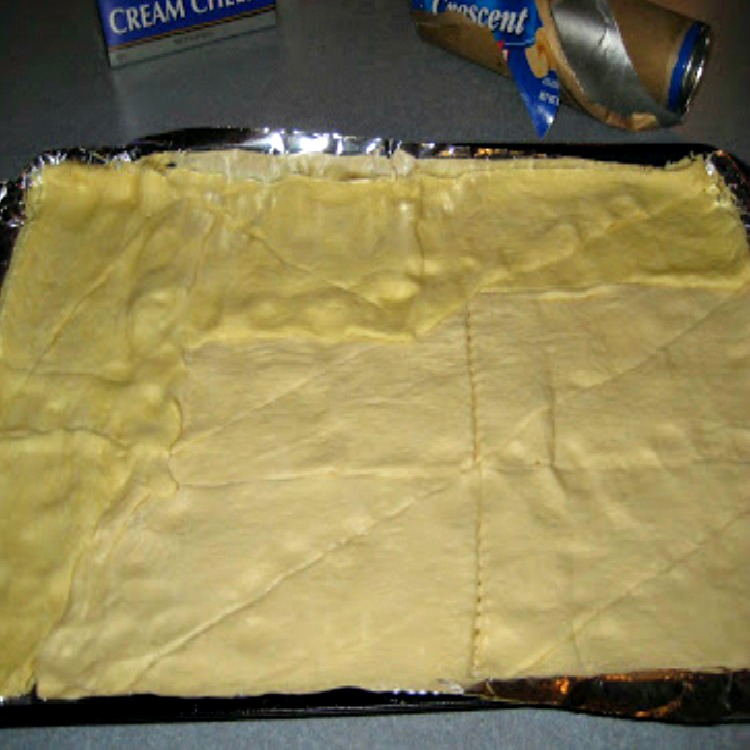 Crescent Rolls Pressed Together on Baking Sheet
