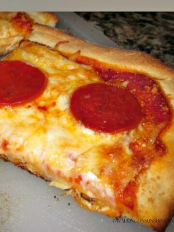 Slice of Homemade Pizza with cheese and pepperoni.