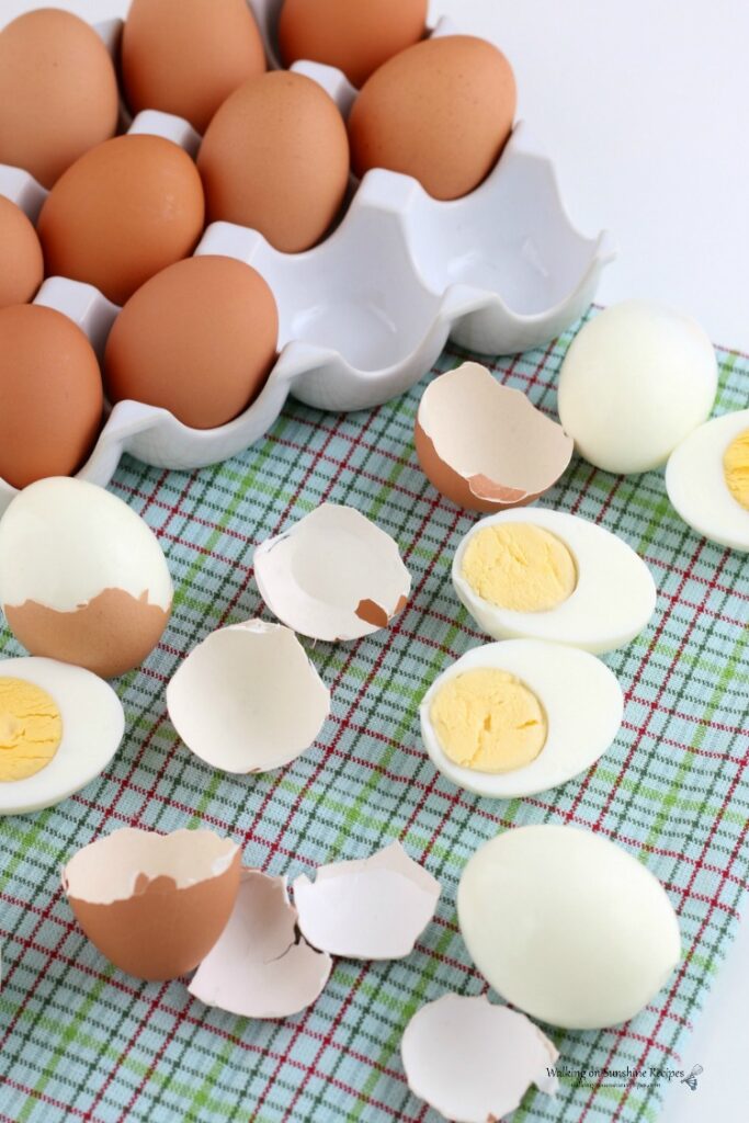 Hard Boiled Eggs with brown shells on green towel
