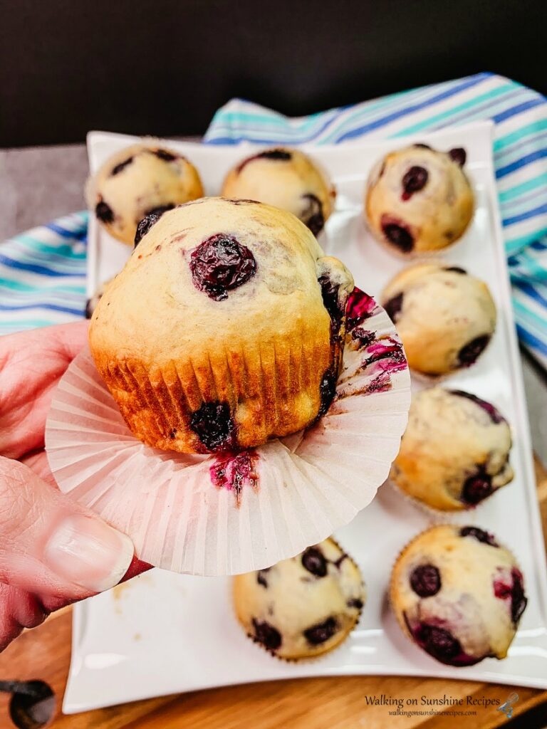 Homemade Blueberry Muffins baked in muffin wrapper and white tray from WOS