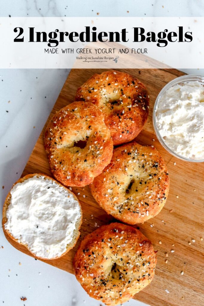 Bagels spread with butter on cutting board