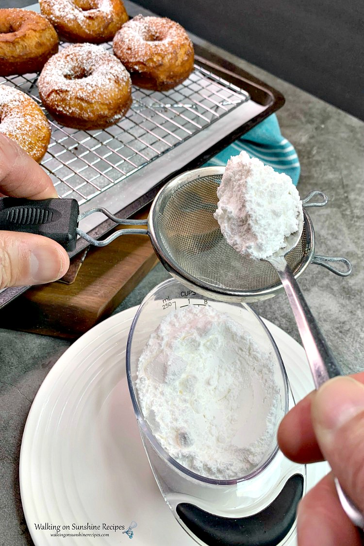 Add powdered sugar to sifter to sprinkle on top of freshly baked donuts