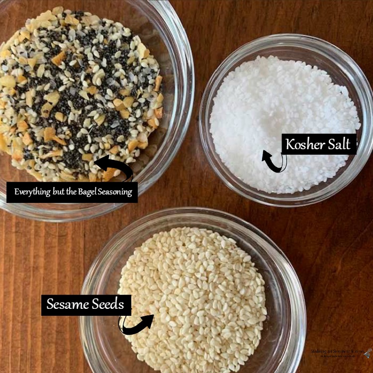 Options for bagel toppings in small glass jars. 