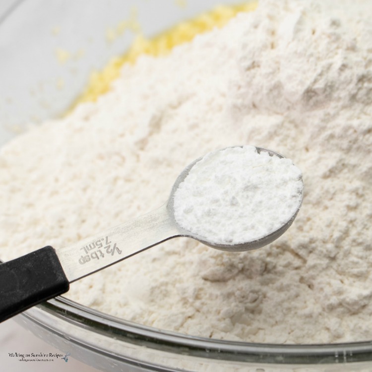 Add Baking Powder to Cake Mix in Bowl