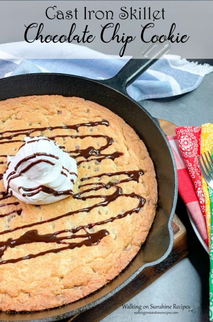 Large chocolate chip cookie made in a cast iron skillet pan.
