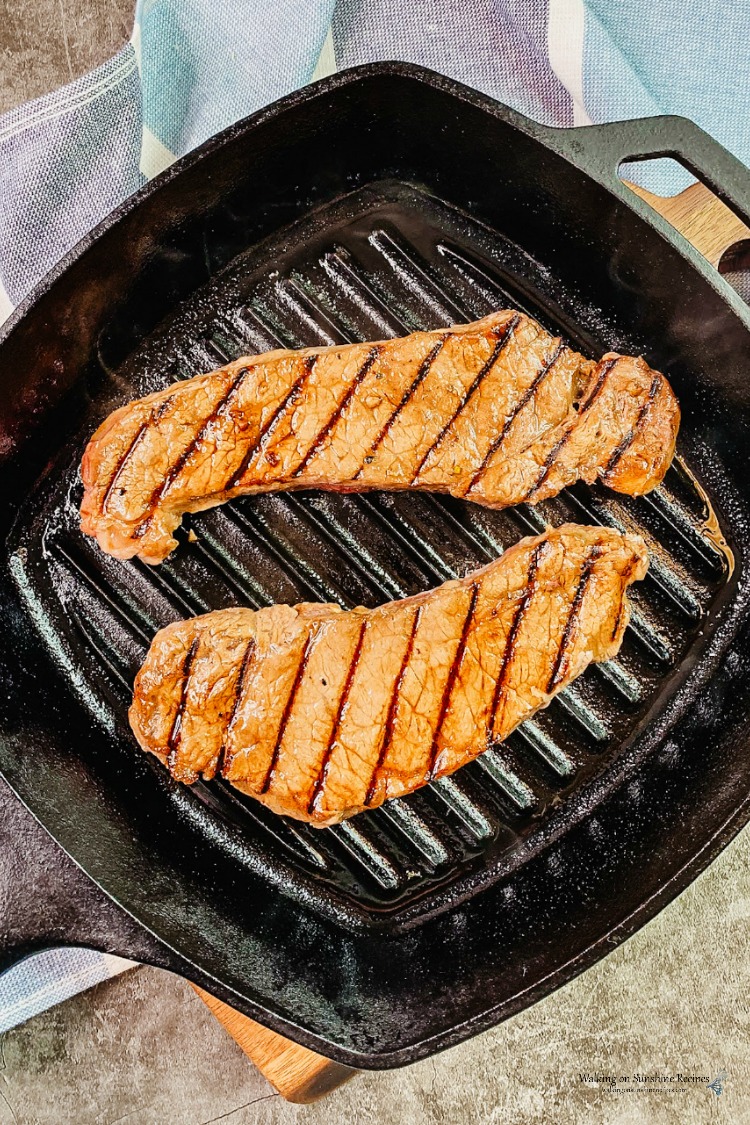 Cooked NY Strip Steaks in Cast Iron Grill Pan