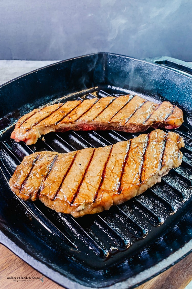 2 New York Strips seared in cast iron grill pan. 