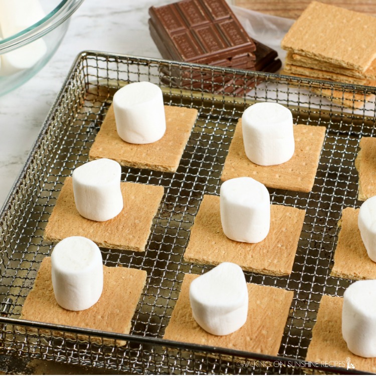 Add marshmallows on top of graham cracker squares in air fryer tray