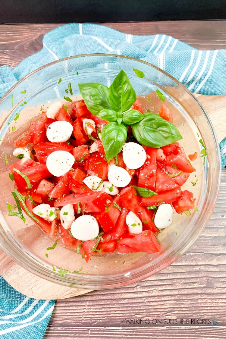 Fresh Tomato Salad in bowl with fresh basil leaves