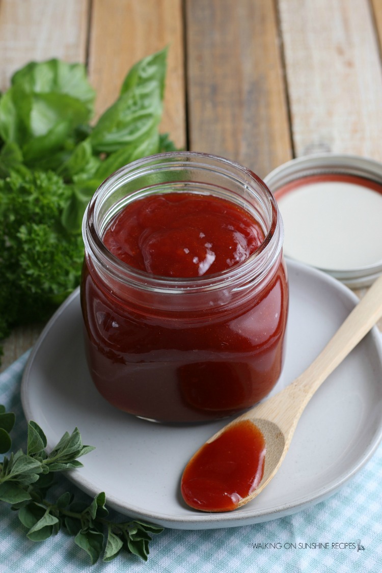 Homemade Barbecue Sauce in mason jar on white plate