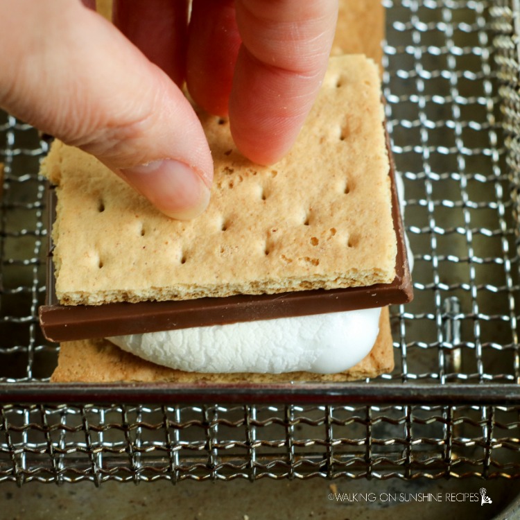 Press the crackers together to get the marshmallow to melt the chocolate