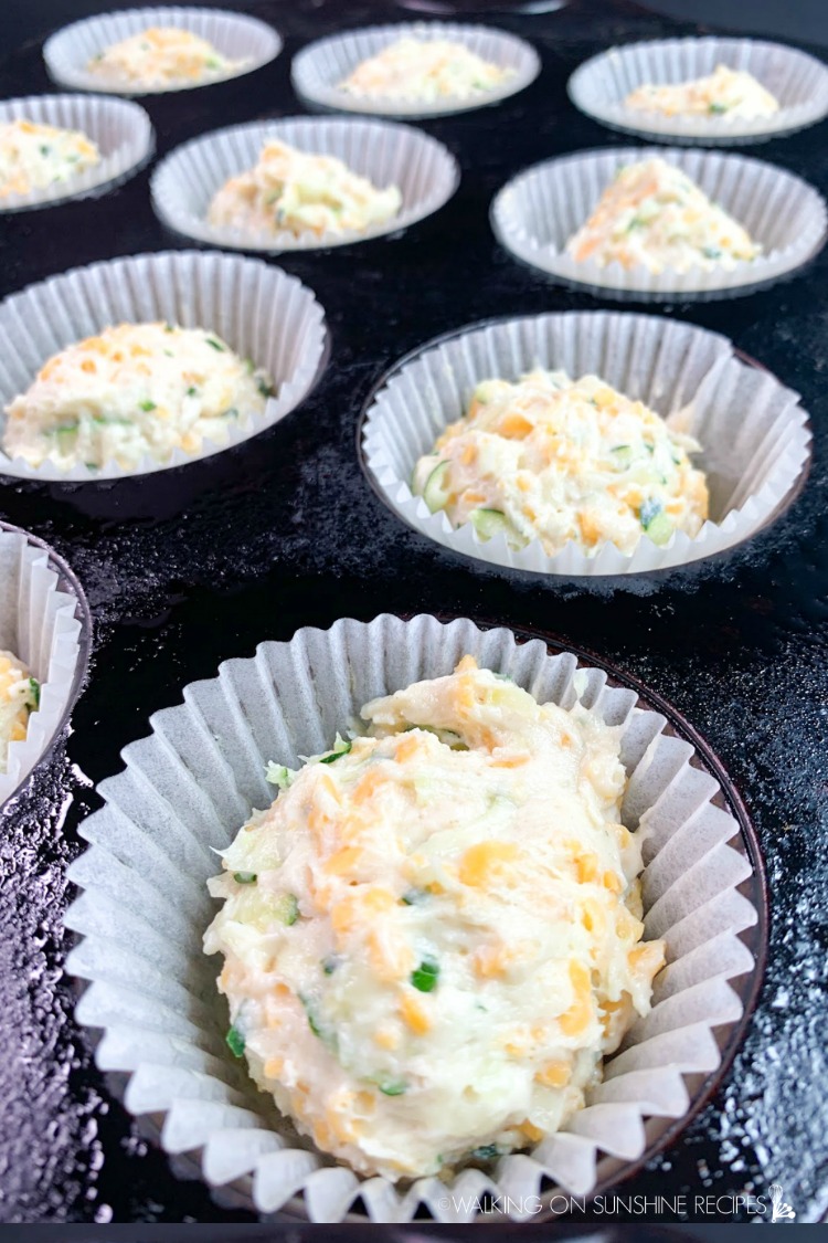 Closeup of Zucchini Cheese Muffin batter in muffin pan