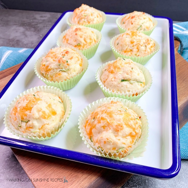 Featured photo Bisquick Zucchini Cheddar Muffins on white and blue tray