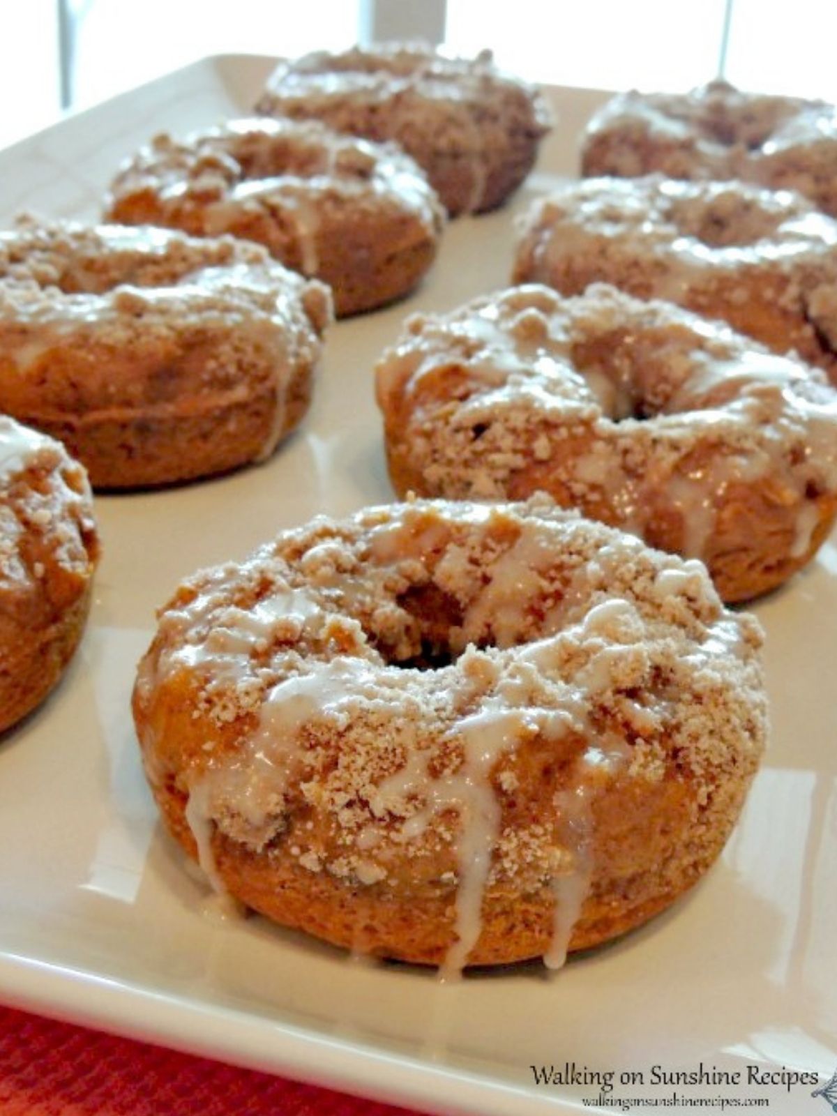Pumpkin Donuts with crumb topping and powdered sugar glaze. 