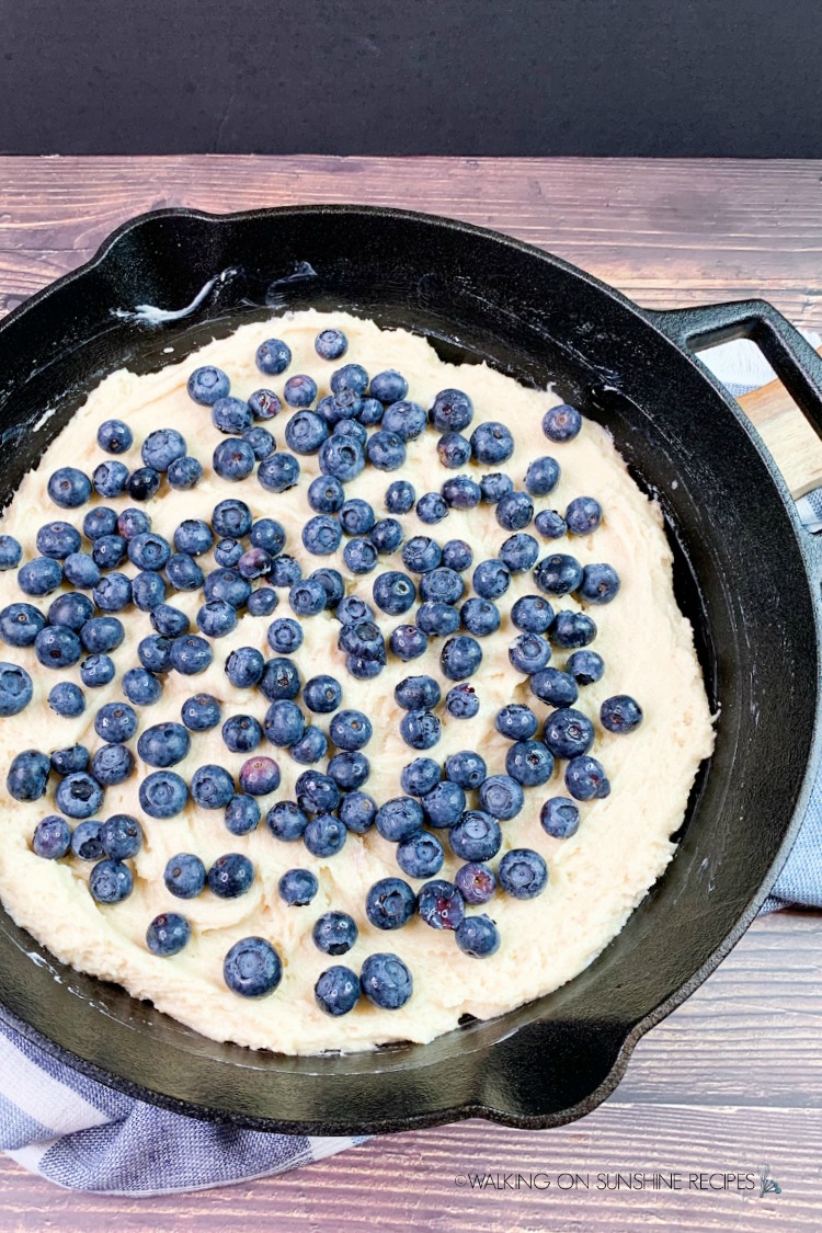 Coffee Cake topped with fresh berries in cast iron skillet pan