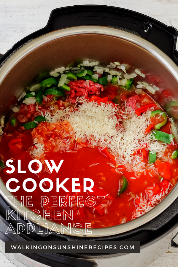 Slow cooker with rice, peppers, tomatoes. 