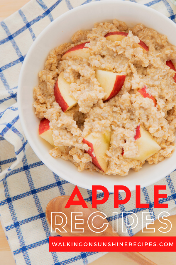 Bowl of oatmeal with apples on blue plaid napkin.