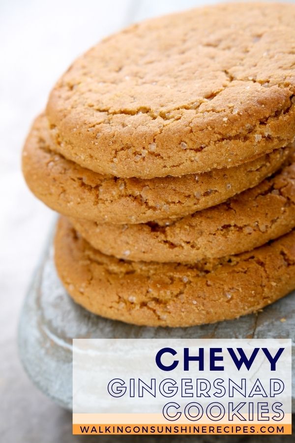 Chewy Gingersnap cookies stacked on marble stone.