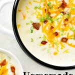 bowl of potato soup topped with bacon, sour cream and cheese.