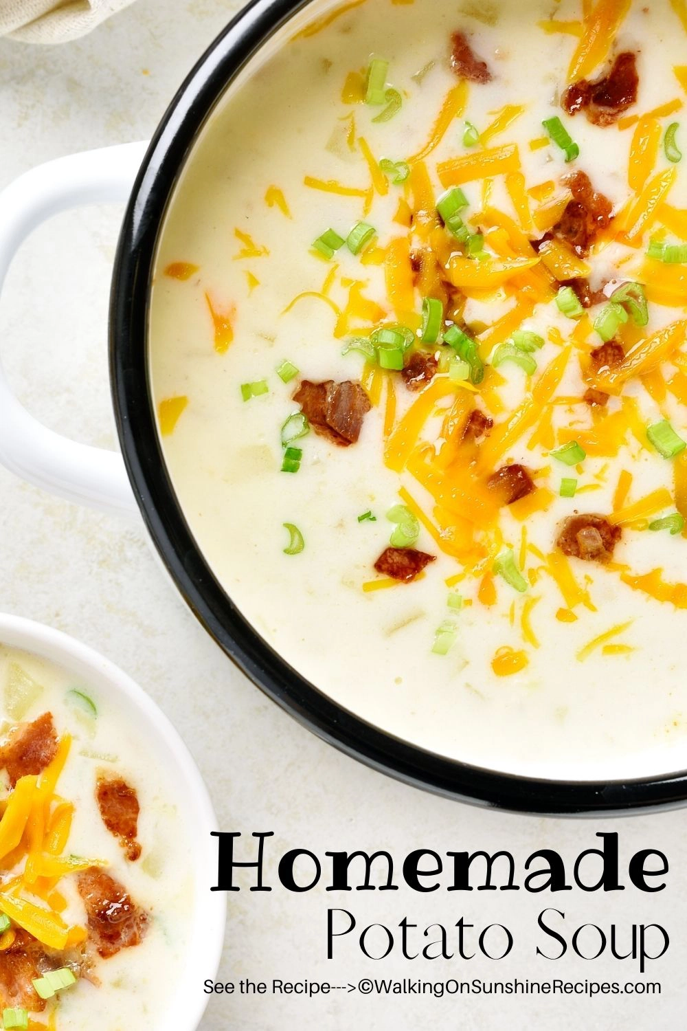 bowl of potato soup topped with bacon, sour cream and cheese. 