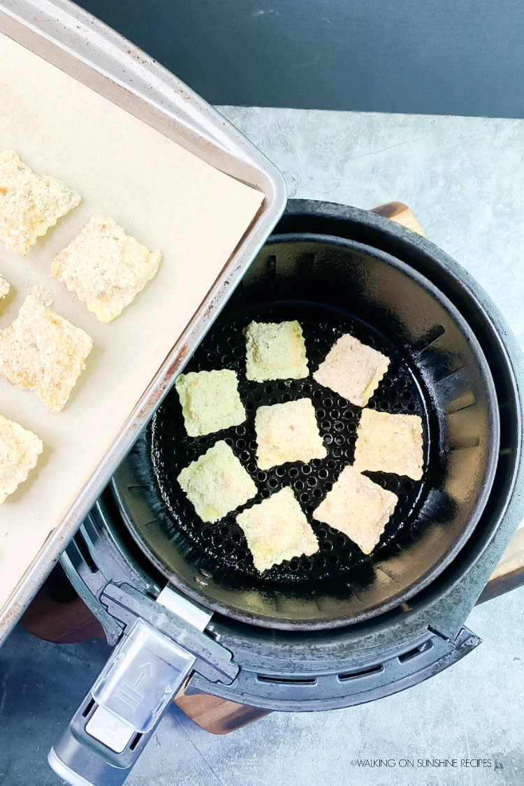 Add breaded mini ravioli to air fryer basket