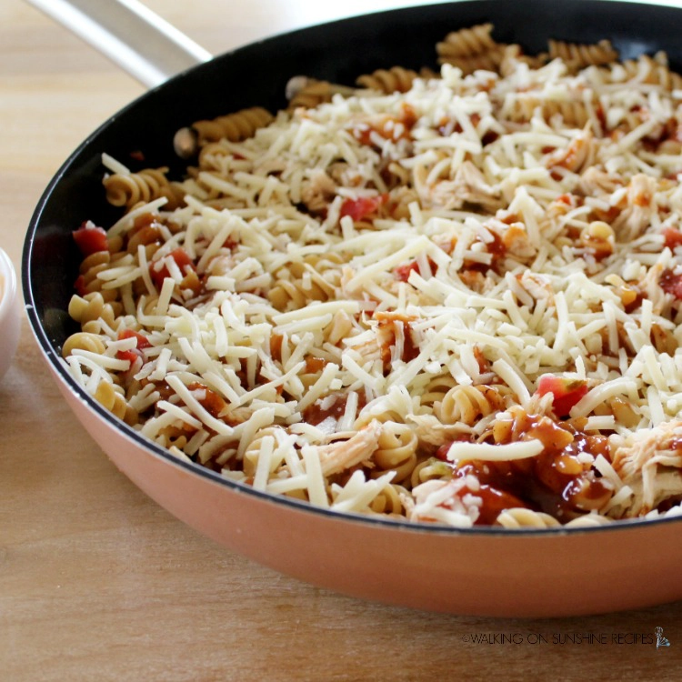 Add cheese on top of pasta and chicken.