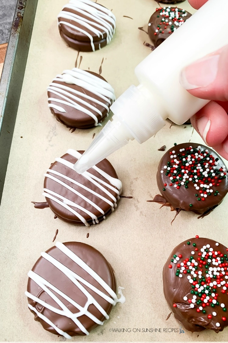 Drizzle melted white chocolate over the tops of the hardened chocolate dipped Oreos
