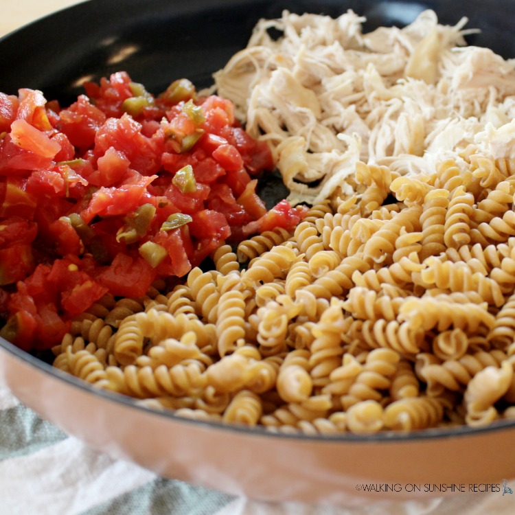 Pasta, Tomatoes and chicken in skillet.