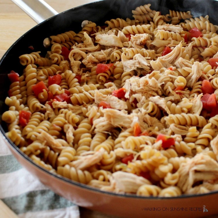 Pasta with tomatoes and chicken in skillet