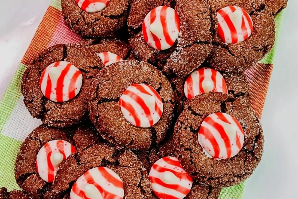 Chocolate cookies with a red and white striped peppermint kiss pressed into the center of each cookie