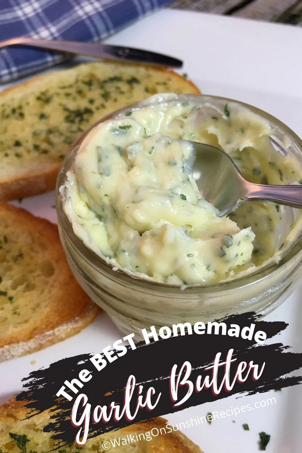 Garlic butter spread recipe in small mason jar with toasted garlic bread on plate. 