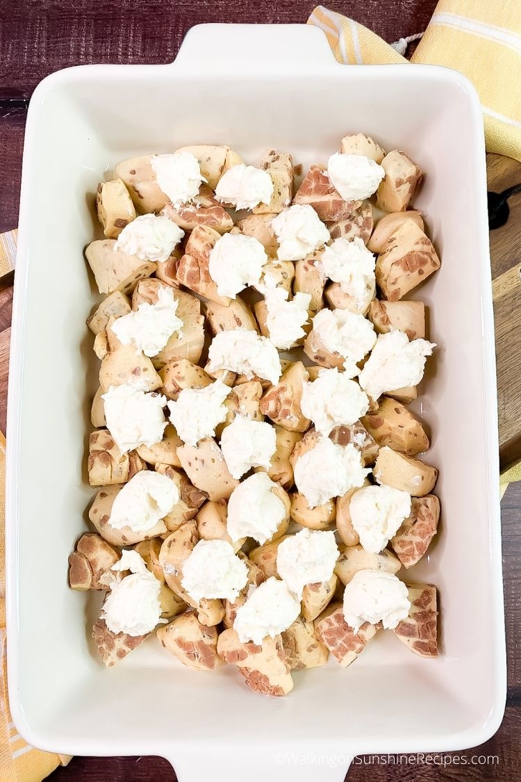 Add cream cheese filling to Pillsbury Cinnamon Rolls Casserole.