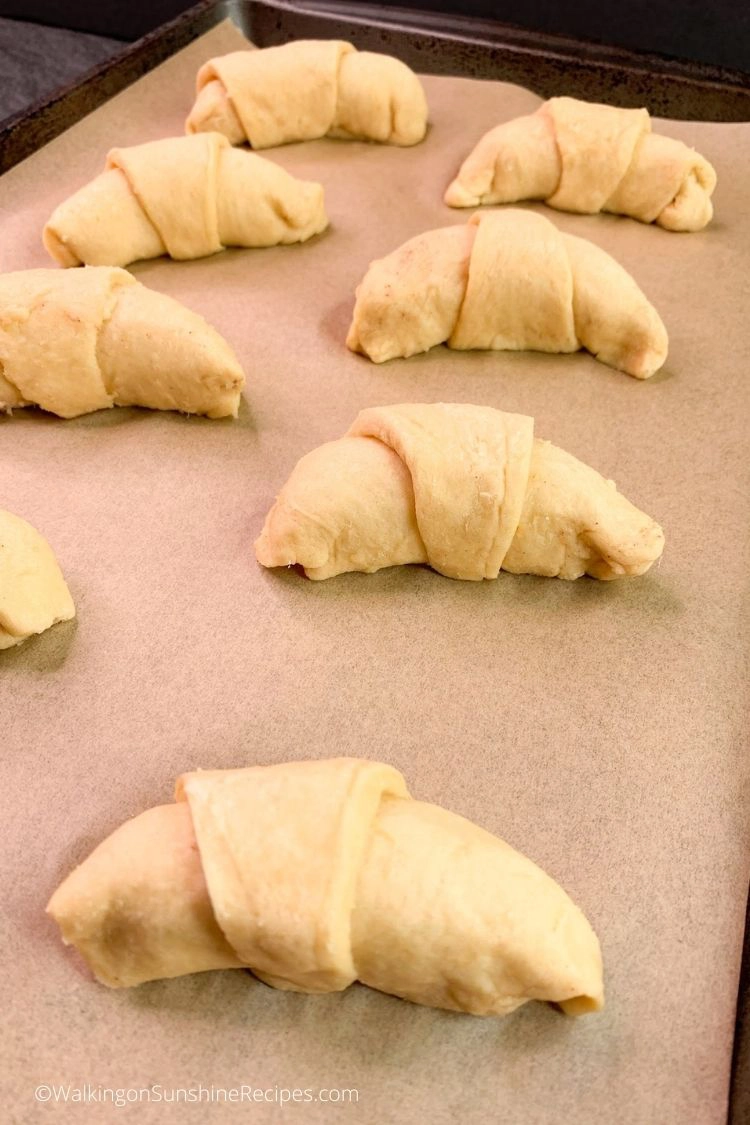 Place the crescent rolls on a parchment paper lined baking tray. 