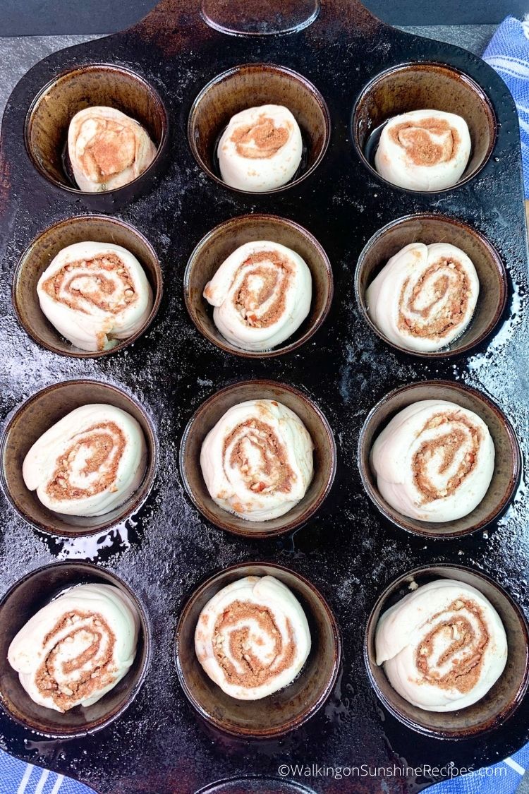 cinnamon rolls in muffin pan ready for the oven. 