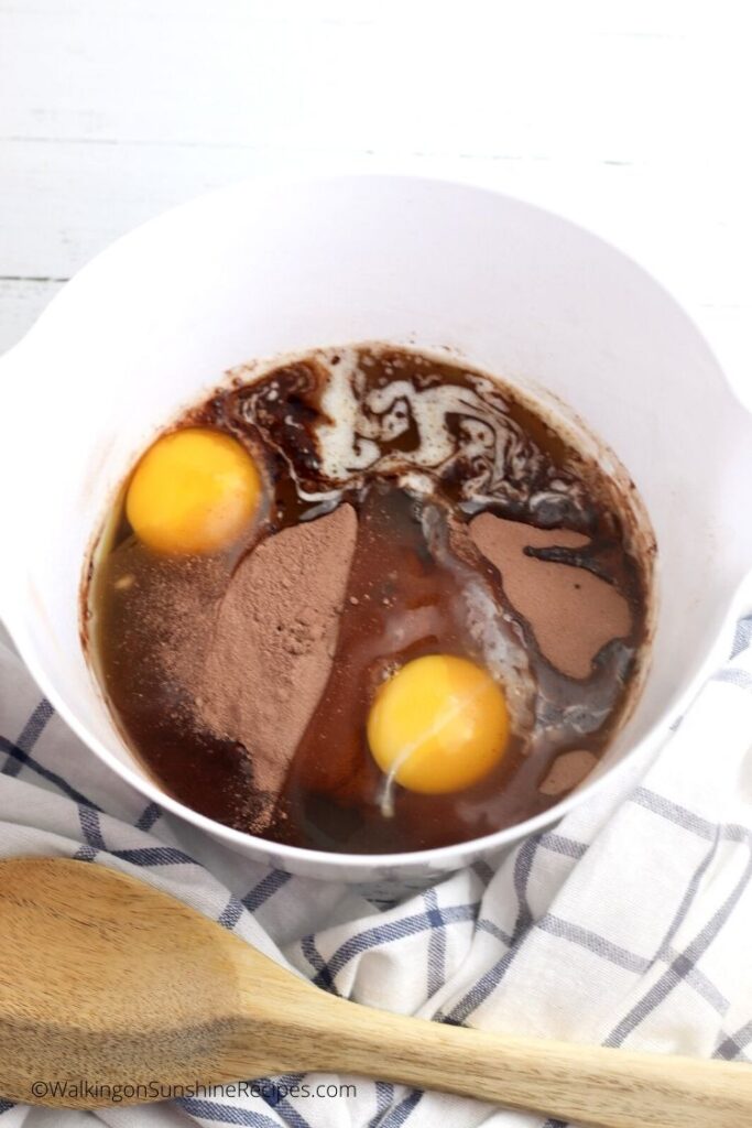 eggs, oil and brownie mix for cookies in mixing bowl. 