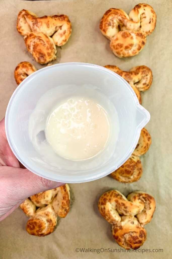 cinnamon roll frosting in small container.