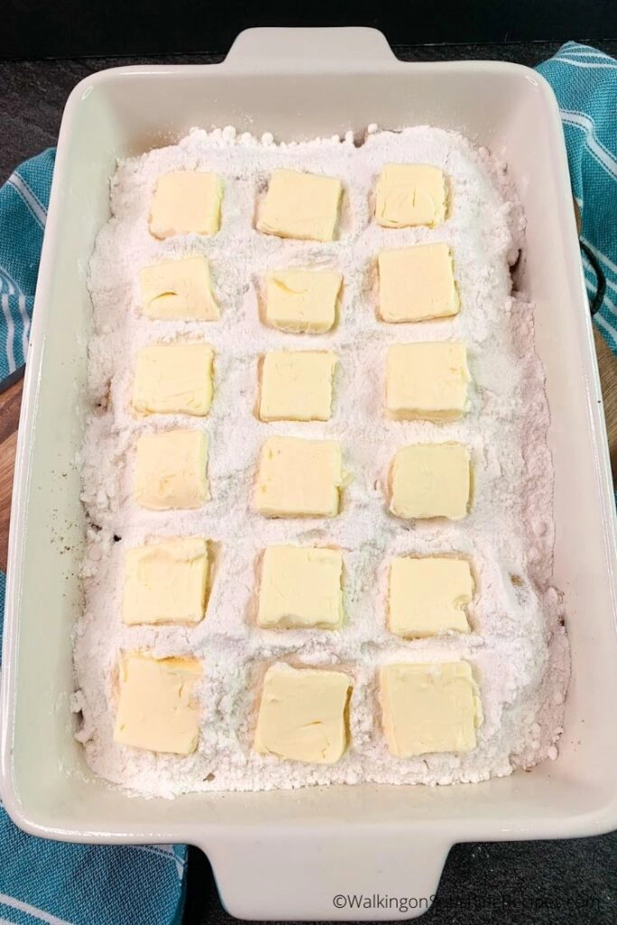 dump cake with white cake mix and butter slices. 