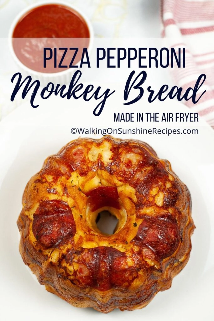 Pizza monkey bread filled with cheese and pepperoni baked in a bundt pan in the air fryer. 
