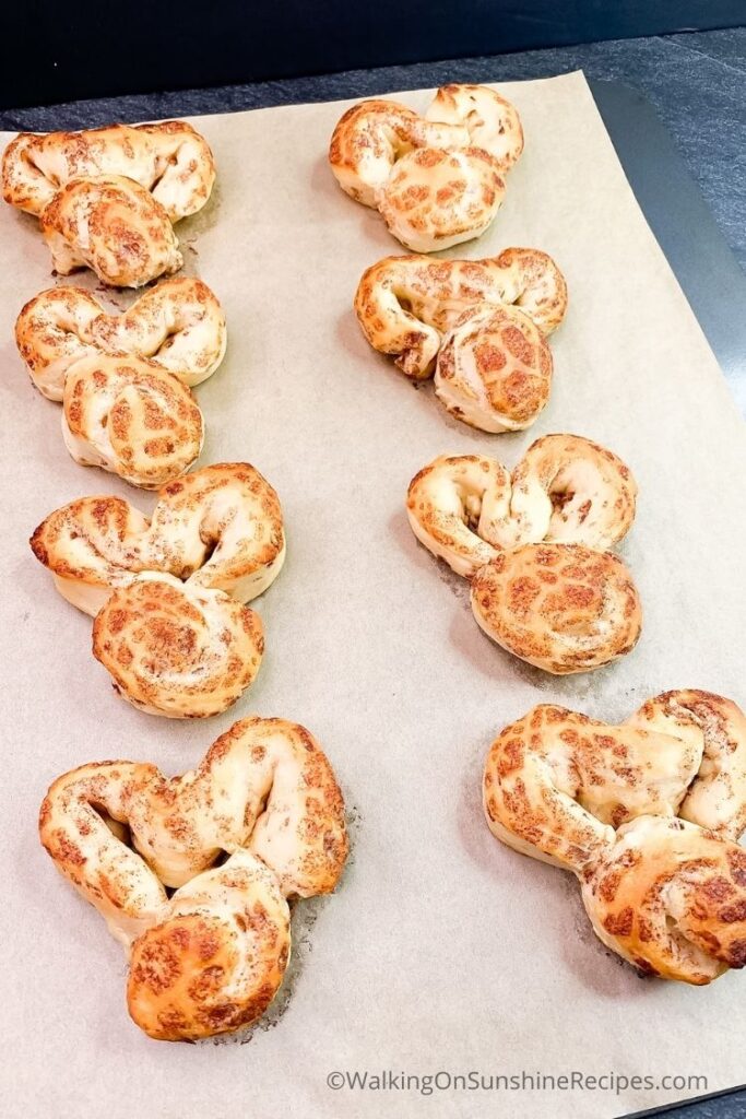 baked bunny cinnamon rolls on parchment paper lined tray.