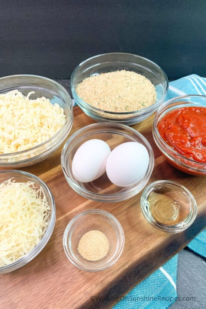 Ingredients for crispy chicken cutlets with marinara sauce and cheese. 