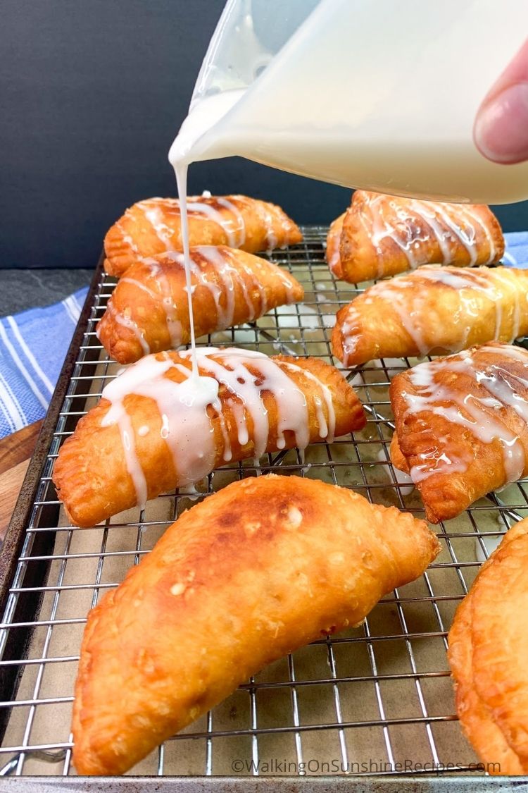 Drizzle powdered sugar glaze on top using a measuring cup. 