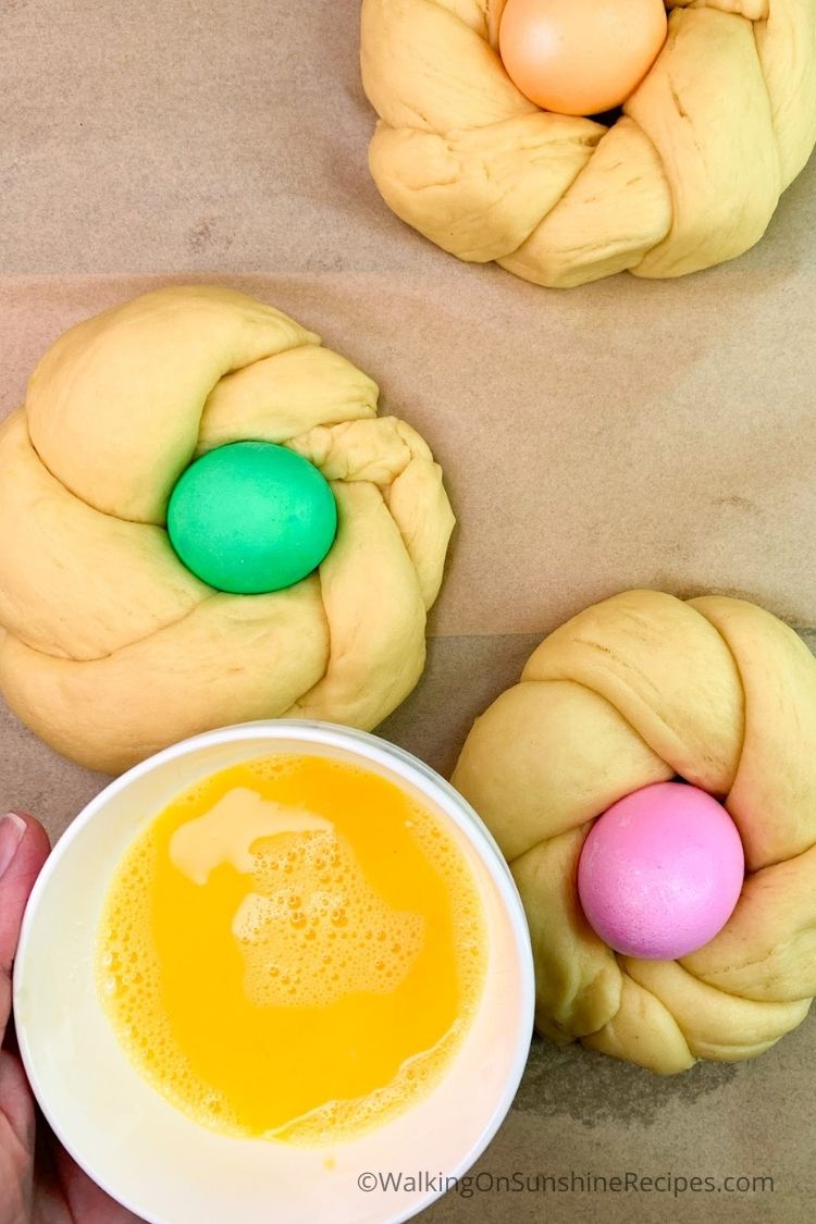 Colored eggs in bread dough rings. 