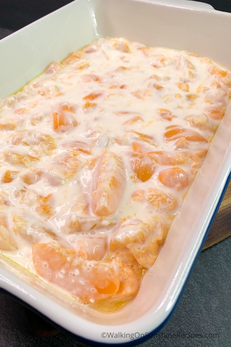 peaches and sweetened cream cheese mixture in baking dish. 