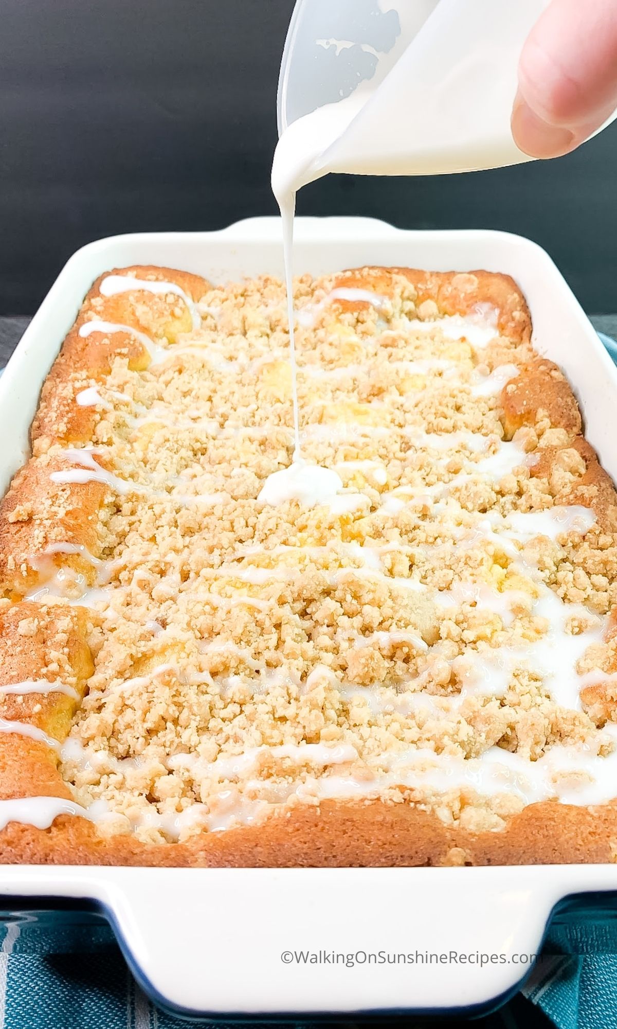 Pour glaze on top of baked peach crumb cake.