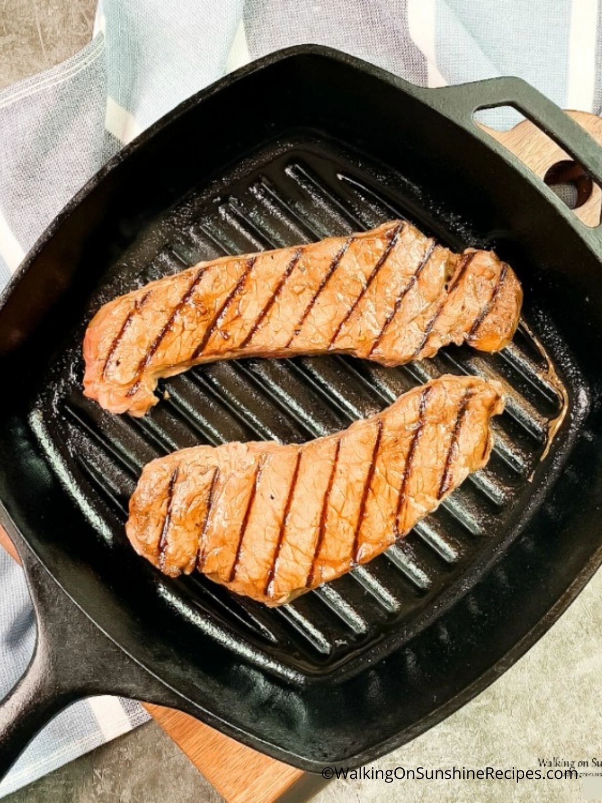 Steak cooked in a cast iron grill pan. 