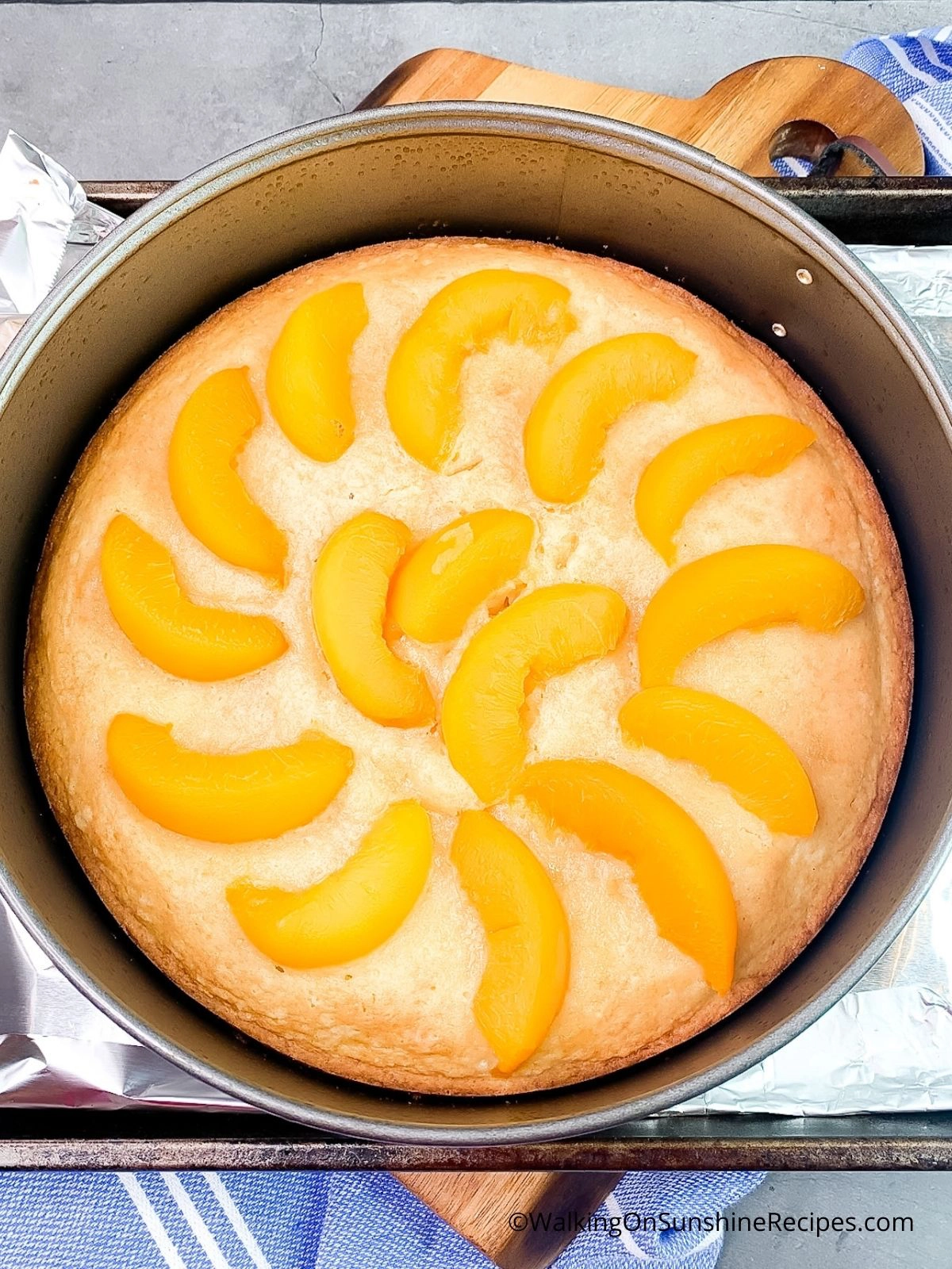Add canned peaches to partially baked peach cake